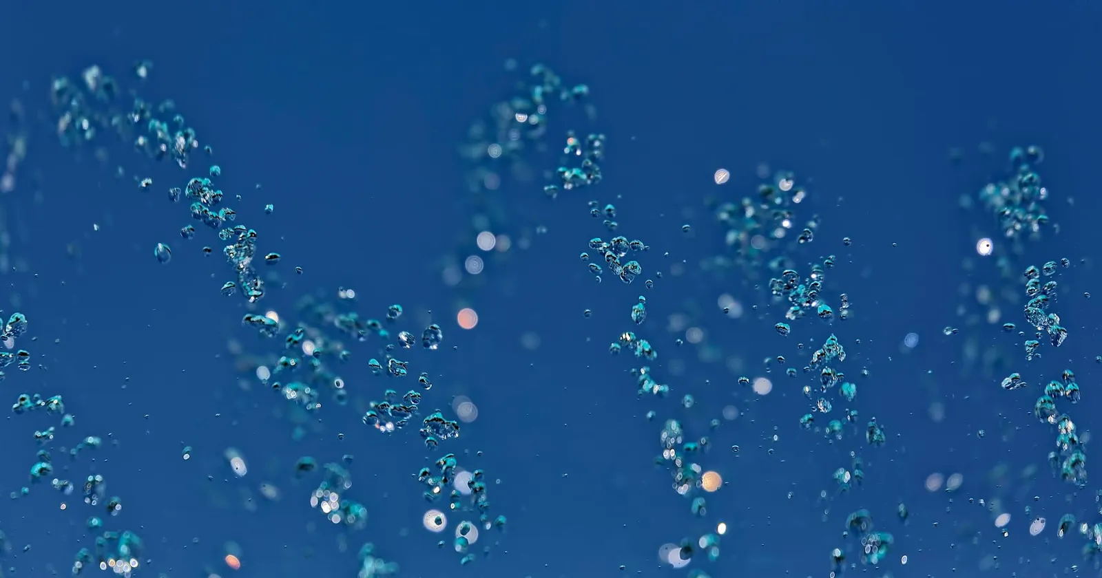 An abstract, closeup image of water bubbles under water